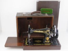 A vintage Singer sewing machine in case.