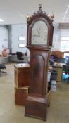 An eight day striking long case clock having painted arch top dial, Roman numerals,
