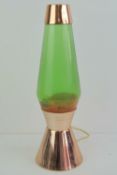 A vintage Astro style orange lava lamp having copper top and stand, for re-wiring.