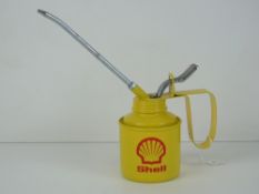 A 1/2 pint oil can having yellow ground with Shell logo upon.