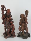 A finely detailed hand carved Japanese deity figurine with staff, 32cm high.