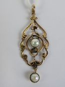 A 9ct gold and pearl Edwardian pendant having scroll work design frame, stamped 9ct (slightly worn),