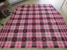 A well woven heavy Welsh style blanket having geometric design in reds,