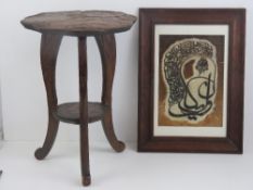 A small carved wooden table of foliate form raised over three supports, 50cm high.
