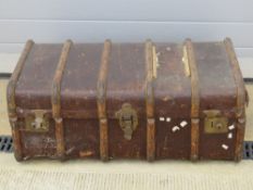 A vintage steamer trunk with leather end handles, a/f.