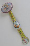 A Chinese Canton enamel on brass ruyi sceptre having deity and floral design upon yellow ground,