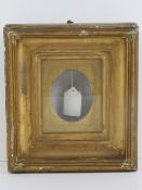 Miniature gilt frame: a deep gilt wood and gesso glazed wall hanging frame for an oval picture,
