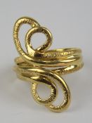 An unusual 18ct gold scrollwork ring, having three rows forming double loop to each side,