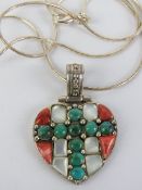 A silver heart shaped pendant set with faux coral, mother of pearl and turquoise, stamped 925,