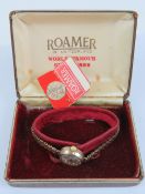 A 9ct gold ladies Roamer cocktail watch having 9ct gold strap,