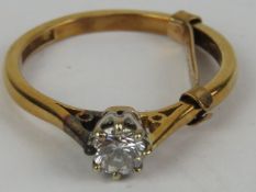 An 18ct gold, platinum and diamond solitaire ring, round cut brilliant diamond approx 0.