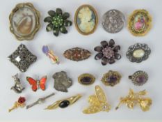A quantity of vintage brooches including a Victorian spinning fob mourning brooch a/f having