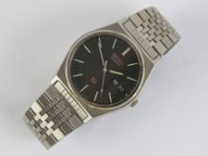 A Seiko Quartz 8023-6040 stainless steel wristwatch having black dial with day and date apertures,