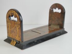 A Victorian Gothic book-slide: a superb quality burr walnut ebonised folding telescopic