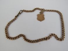 A 9ct rose gold curb link chain having gilt metal clasp and 9ct rose gold engraved shield fob upon.