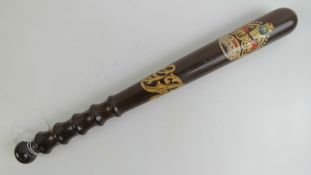 An early 20th century mahogany truncheon having crown and GR cypher upon, four finger turned grip,