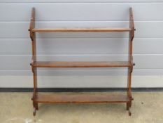 A late 19th century set of three hanging wall shelves in oak, 63cm high.