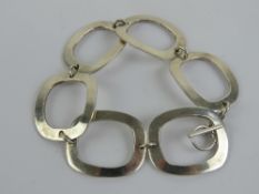 A silver bracelet of abstract form comprising six rectangular open panels, stamped 925, 19.