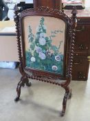 A fine Victorian free standing mahogany fire screen raised over opposing fine quality barley twist