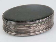 A Georgian HM silver and polished agate oval snuff box, hinge lidded and having gilded interior,
