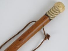 A Georgian Malacca 'Dandy' walking stick: a long shafted malacca cane with turned bone pommel,
