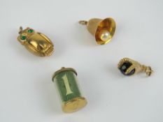Three 9ct gold charms being an owl, 1.9g, a '1' note in tube, and a bell having pearl striker.