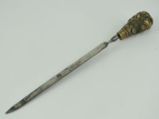 A late Victorian paper knife; cast brass dogs head handled paper knife with nickel plated blade,