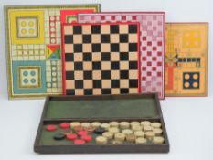 A hinged chequer-top board opening to reveal a quantity of 19th century turned ivory draft pieces