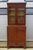 An oak bookcase on chest, twin glazed do