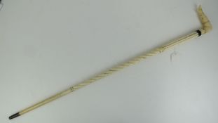 A carved whalebone cane having ladies le