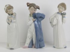 Three Nao figurines each being a young c
