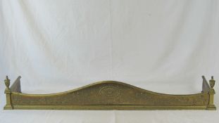 A late Edwardian solid brass fender havi