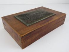 A simple lidded mahogany box having cast