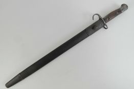 A WWI British SMLE 1907 pattern hook quillion bayonet with 43cm blade and leather scabbard.
