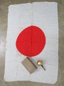 A WWII Japanese Red Cross flag with flag pole top in box.