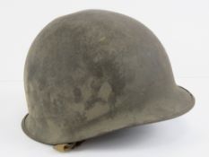 A WWII US Army helmet, marked 1209D within.