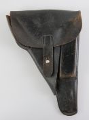 A WWII German P38 holster with spare magazine, having German marks upon and dated 1940.