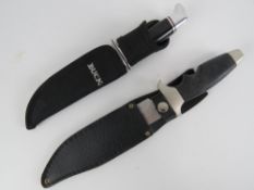 Two knives with scabbards; Best Defence 440 steel and Buck.