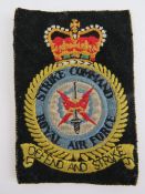 A Strike Command Royal Air Force 'Defend and Strike' embroidered cloth badge, 11 x 8cm.