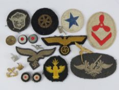 A quantity of assorted military cloth patches with two cockade badges, pin badge, etc.