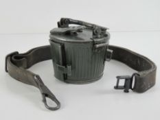 An MG42 leather sling and drum magazine.