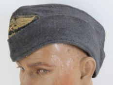 A WWII German Luftschutz side cap, dated 1941.