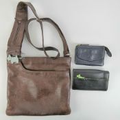 A brown leather Radley handbag, together with two Radley purses. Three items.