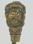 A late Victorian paper knife; cast brass dogs head handled paper knife with nickel plated blade,