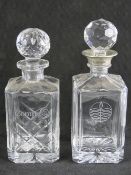 Two cut glass decanters, on with metal rim, 25cm and 27cm high respectively, each with stopper.