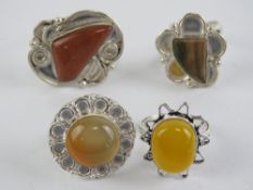 Four hardstone rings each stamped 925, size R-S, including goldstone.