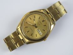 A Seiko 5 wristwatch with box, papers and additional links, skeleton back, stainless steel strap,