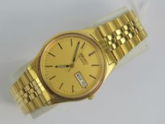 A gold plated Seiko with day and date aperture, yellow metal hands and batons,
