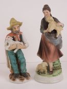 Two hand painted Continental pottery 20th century shepherd figurines, 21cm and 24cm respectively,