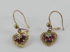 A pair of 9ct gold diamond and ruby heart shaped earrings, hallmarked 375 to hanger, 2.